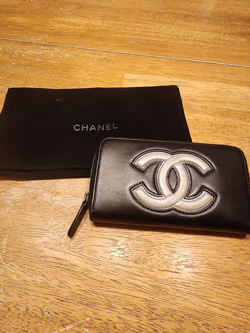 Chanel Timeless CC zip-around wallet features smooth black leather